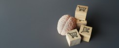 A human brain and wooden blocks with shopping carts icon.