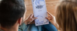 back view of blurred couple holding menu in restaurant