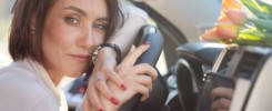 beautiful modern fashionable girl sitting in her car and thinking