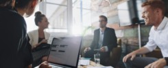 Businesswoman working on laptop in meeting