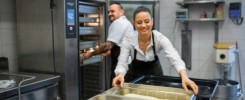 Chef and cook working on their dishes indoors in restaurant kitchen