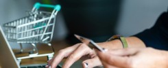 close-up of a woman hands buying online with a credit card and a laptop, e-commerce concept