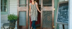 Female shop assistant in doorway of country store