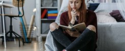 Girl thinking over notebook