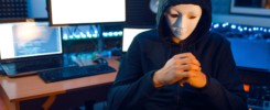 Hacker in mask and hood, illegal risk job