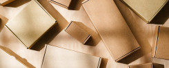 Multiple cardboard boxes arranged on a surface for packaging and shipping in a warehouse setting