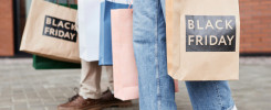 Of couple holding Black friday shopping bags walking together outdoors