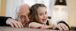 old man and young girl smiling