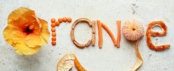 orange,creative typography made with food and flowers on stone table