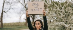 Portrait of cute woman with a banner with the slogan Save the Planet.