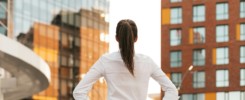 Rear view of businesswoman looking business buildings