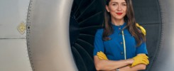 Serene stewardess with loose hair looking at the camera