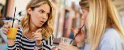 Two women gossiping in a cafe