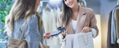 Woman seller and buyer in clothes store