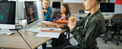 Young IT specialists works on computers in office