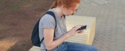 young redhair hipster woman using phone.