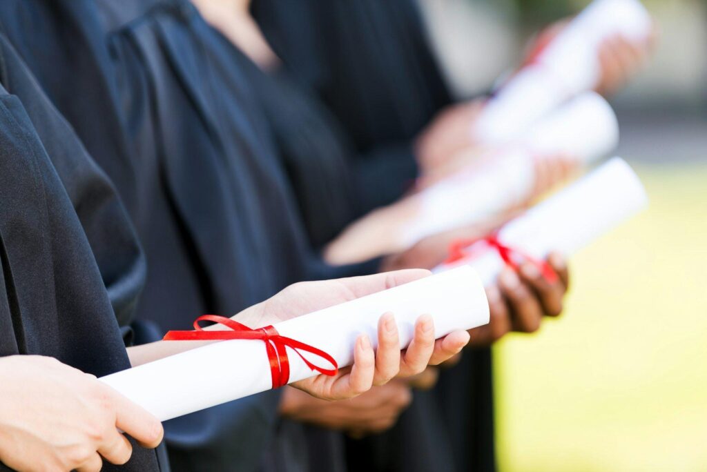 Graduates with diplomas.