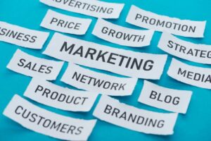 components of marketing on pieces of paper on blue