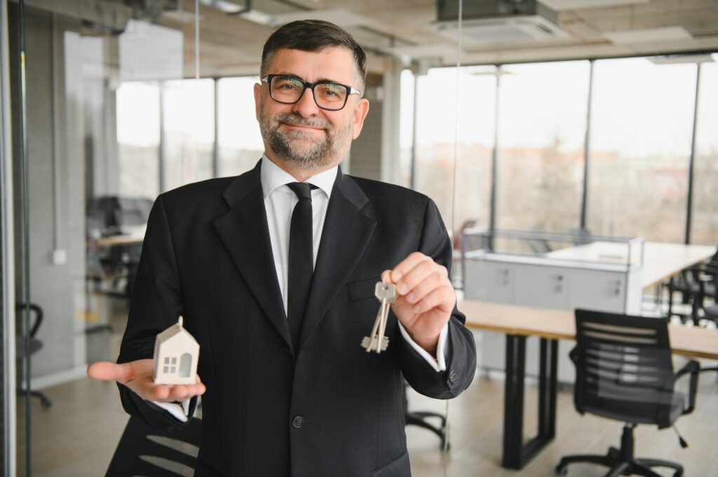 Real estate agent with house model and keys
