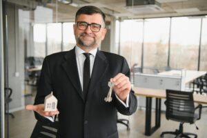 Real estate agent with house model and keys