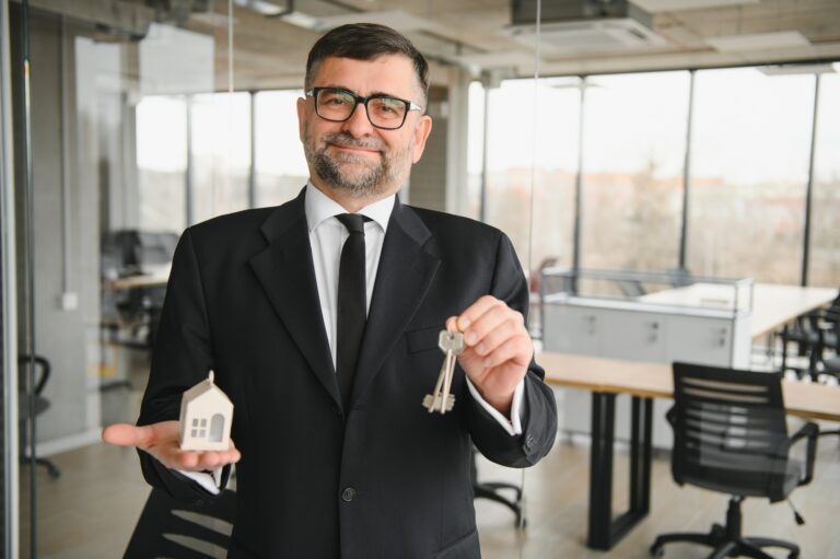 Real estate agent with house model and keys