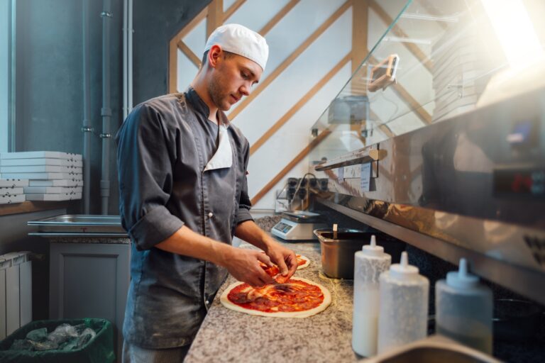 A pizzéria marketing The chef prepares pizza. Catering kitchen work.