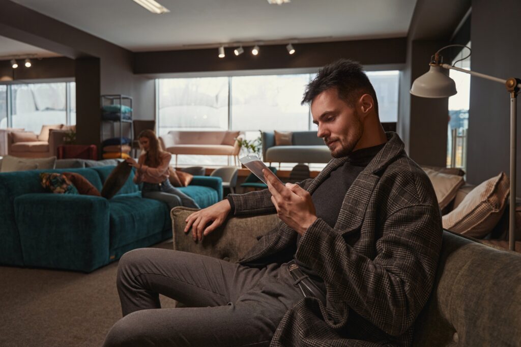 Two buyers selecting new couches in store