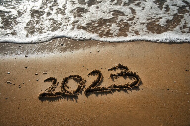 2023 written over the sand of the beach.