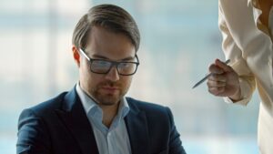 A corporate leader listening to a business finance team in a crisis. Mature leader works