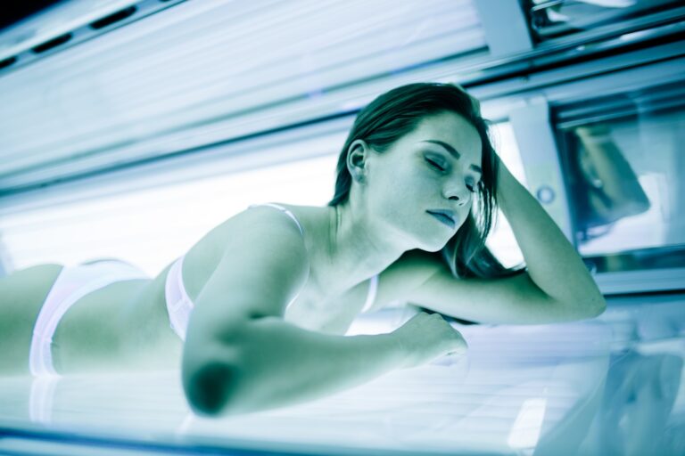 Beautiful brunette sunbathing in solarium