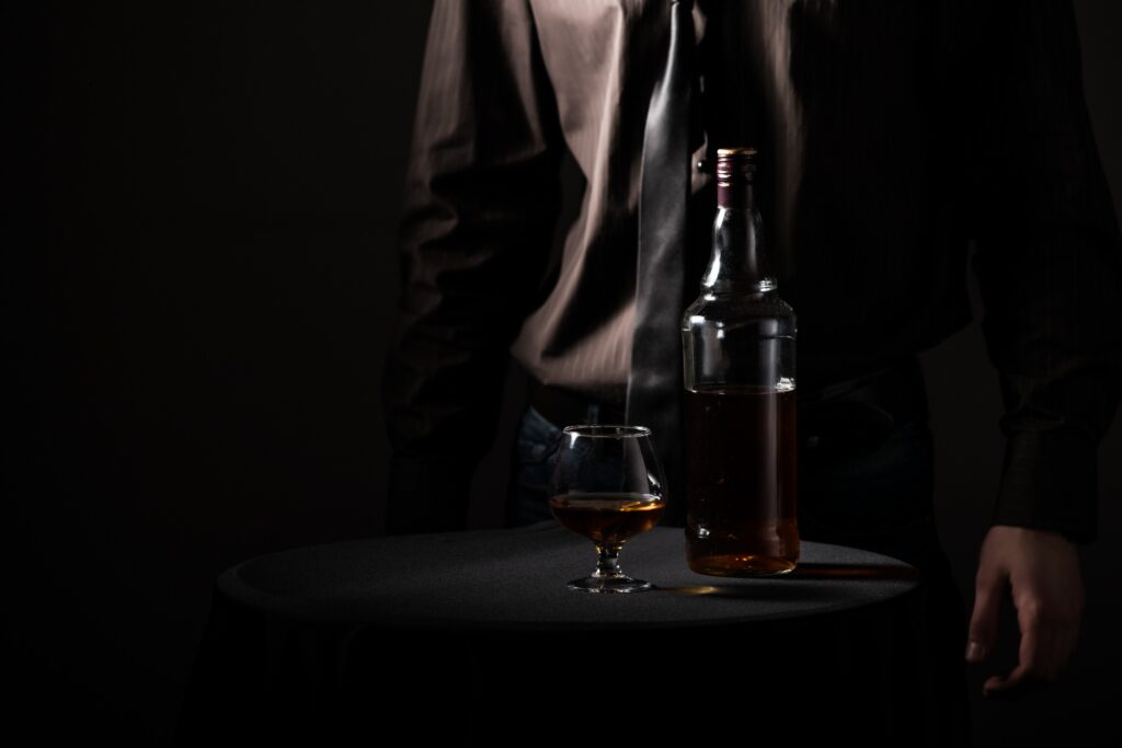 Bottle with an alcoholic drink and a glass