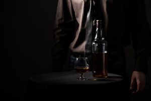 Bottle with an alcoholic drink and a glass