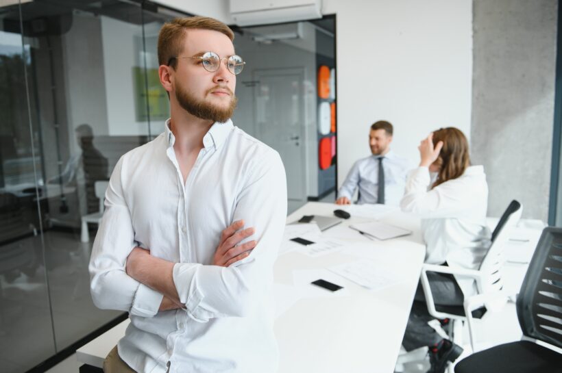 Portrait of a leader with business team behind.