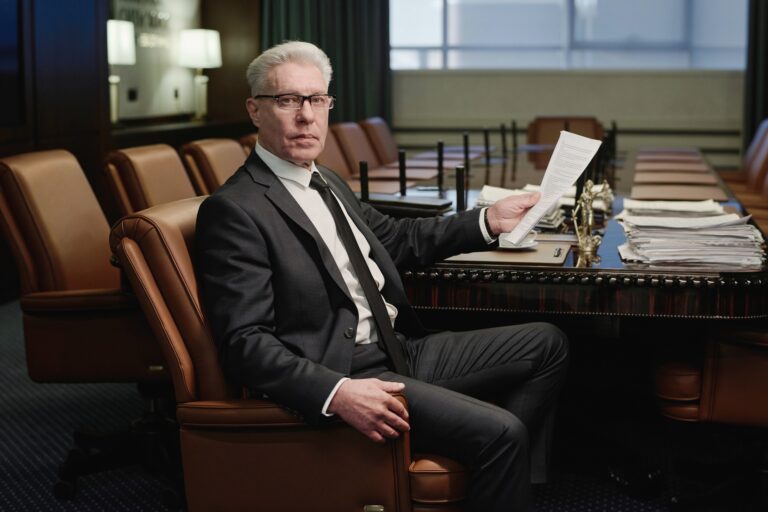 Professional Lawyer Posing in Boardroom While Working with Documents