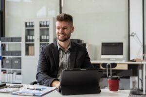 Smiling confident mature businessman leader looking at camera in office.