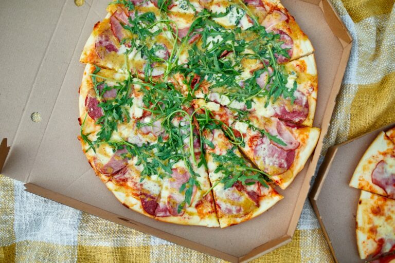 A Pizza Hut adatvezérelt marketingstratégiája Two pizzas in the food carton on the grass, picnic concept, top view, copy space