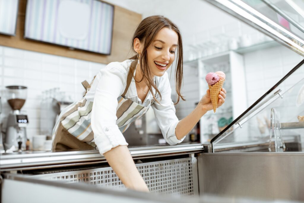 Woman selling ice cream in the shop