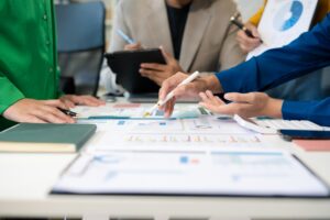 Marketing staff are analyzing the data to business planning at office.