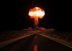 Terrible explosion of a nuclear bomb with a mushroom with road at night. Hydrogen bomb