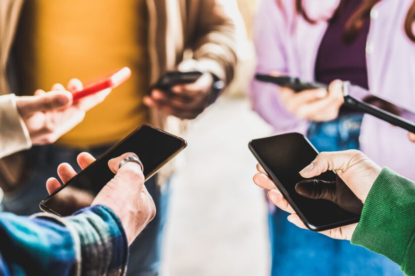 Closeup of people hands using data on mobile smart phones
