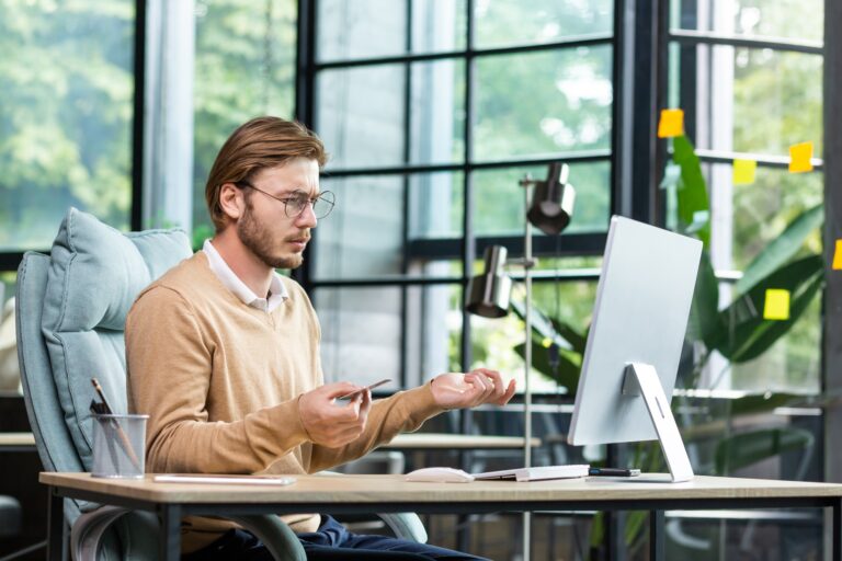 A magyar vállalkozók legnagyobb marketinges kihívásai napjainkban Financial problems. A young male businessman is sitting at a desk in the office and looking