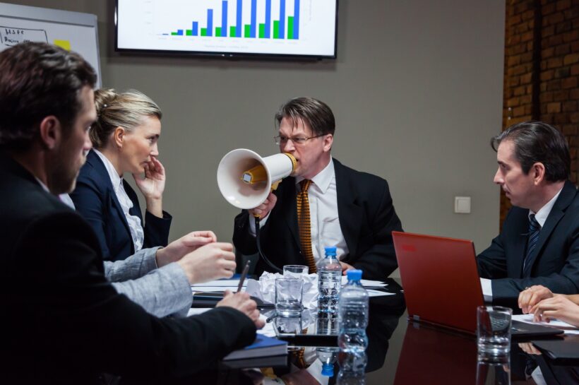 Leader shouting at people in office