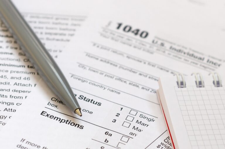 The pen and notebook is lies on the tax form 1040 U