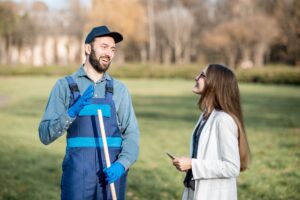 Businesswoman and sweeper in the park