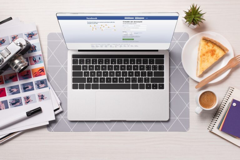 A Facebook története és főbb botrányai office desk with laptop with facebook website on screen, flat lay